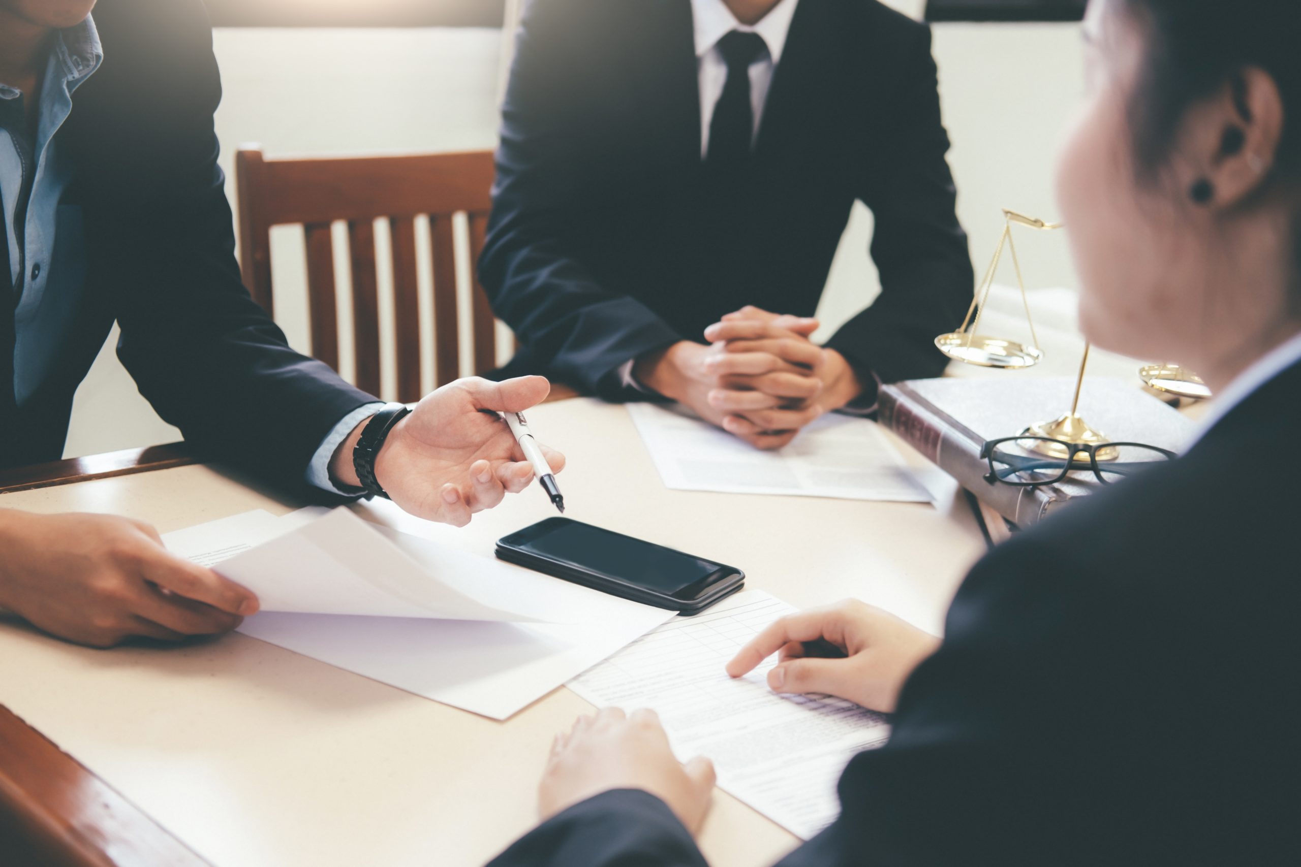 Law, advice and Legal services concept. Lawyer and attorney having team meeting at law firm.
